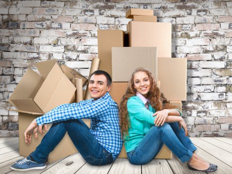 Movers planning a home relocation in Kingston with boxes and furniture